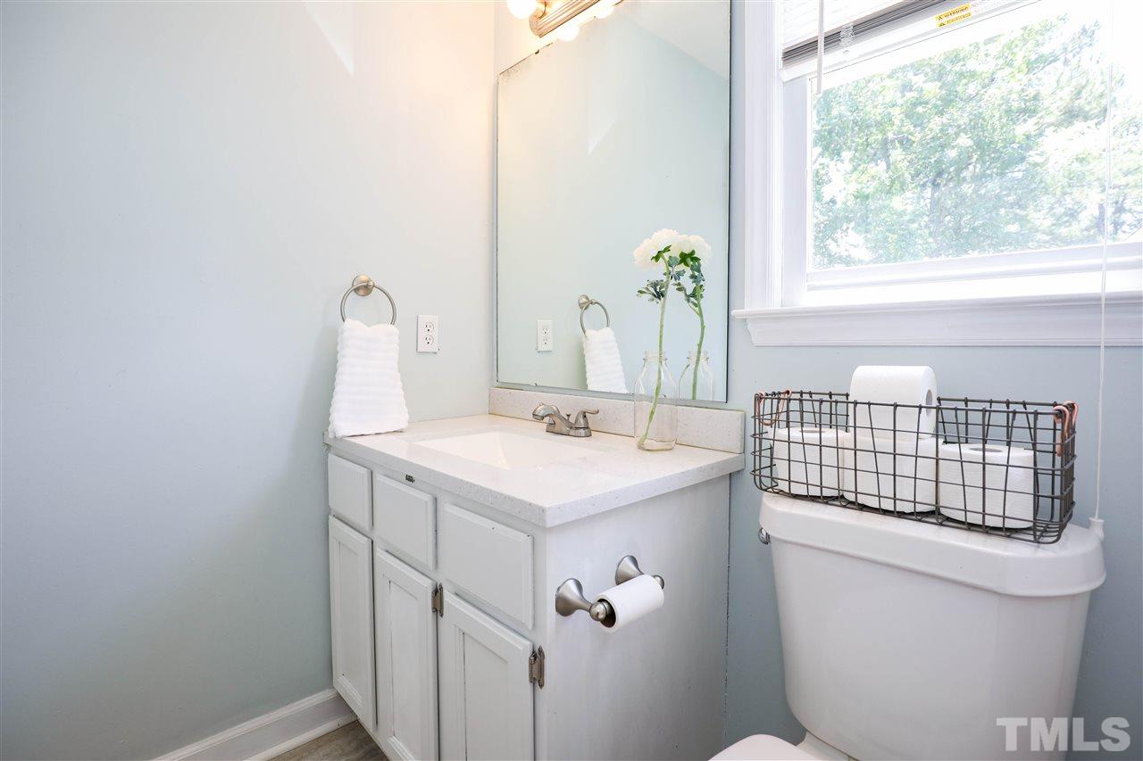 4841 Draper Road Raleigh, NC 27616 - Photo 20 of 30 a bathroom with a sink toilet and window