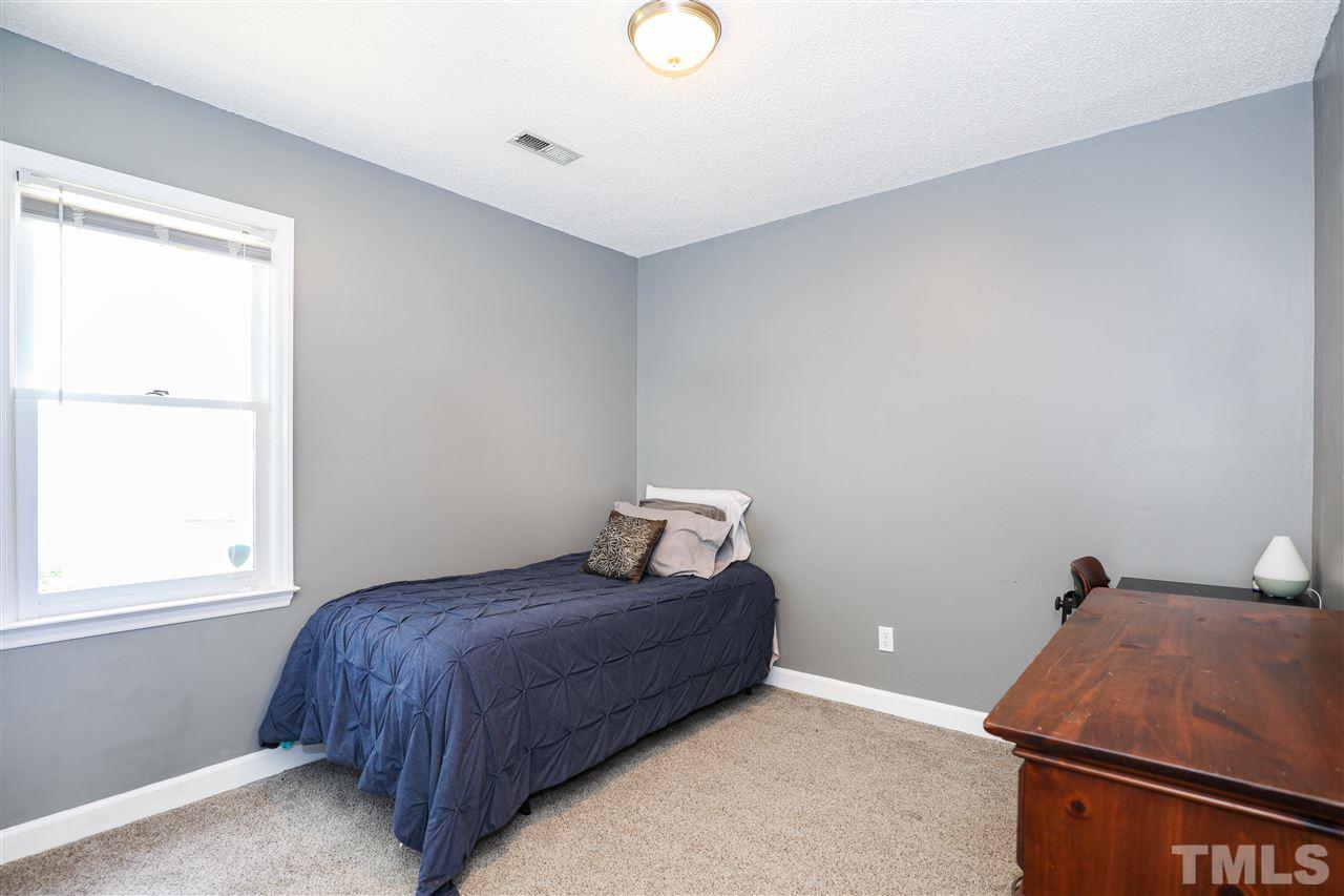 4841 Draper Road Raleigh, NC 27616 - Photo 22 of 30 a bedroom with a bed and window