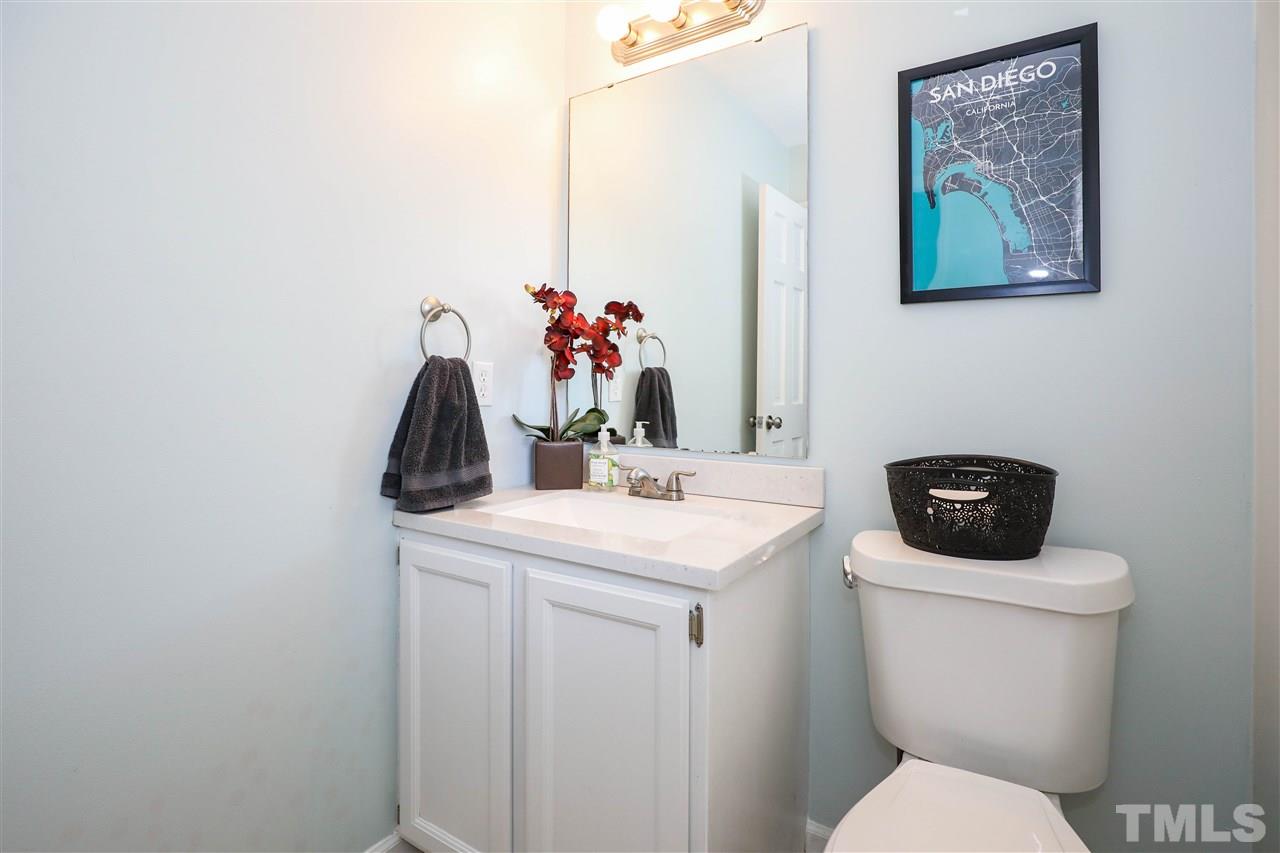 4841 Draper Road Raleigh, NC 27616 - Photo 23 of 30 a bathroom with a toilet sink and vanity