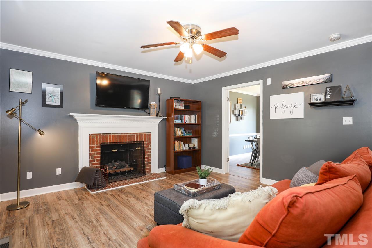 4841 Draper Road Raleigh, NC 27616 - Photo 5 of 30 a living room with furniture and a fireplace