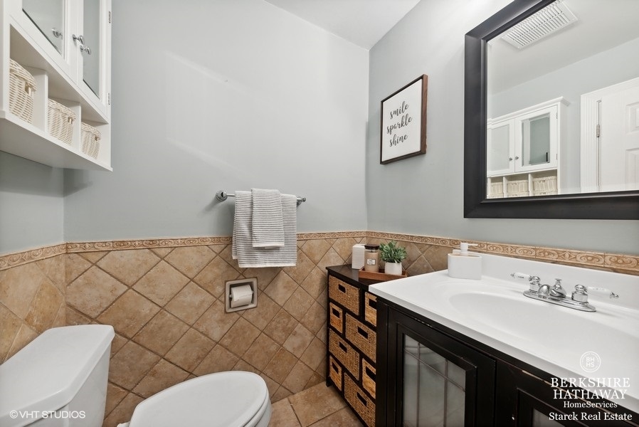 2408 George Street Rolling Meadows, IL 60008 - Photo 12 of 24 a bathroom with a sink a toilet and a mirror