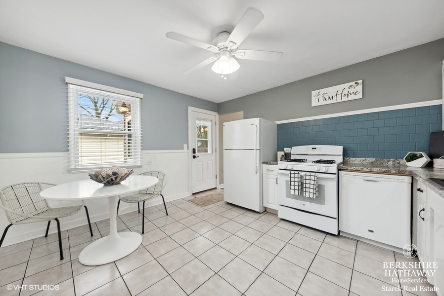 2408 George Street Rolling Meadows, IL 60008 - Photo 4 of 24 a kitchen with furniture a refrigerator and a table