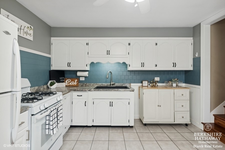 2408 George Street Rolling Meadows, IL 60008 - Photo 6 of 24 a kitchen with stainless steel appliances granite countertop a stove and a white cabinets