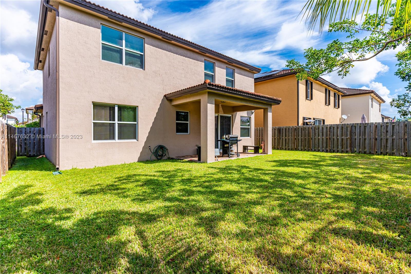 4144 Northeast 21st Street Homestead, FL 33033 - Photo 29 of 33 a view of a house with backyard and a tree