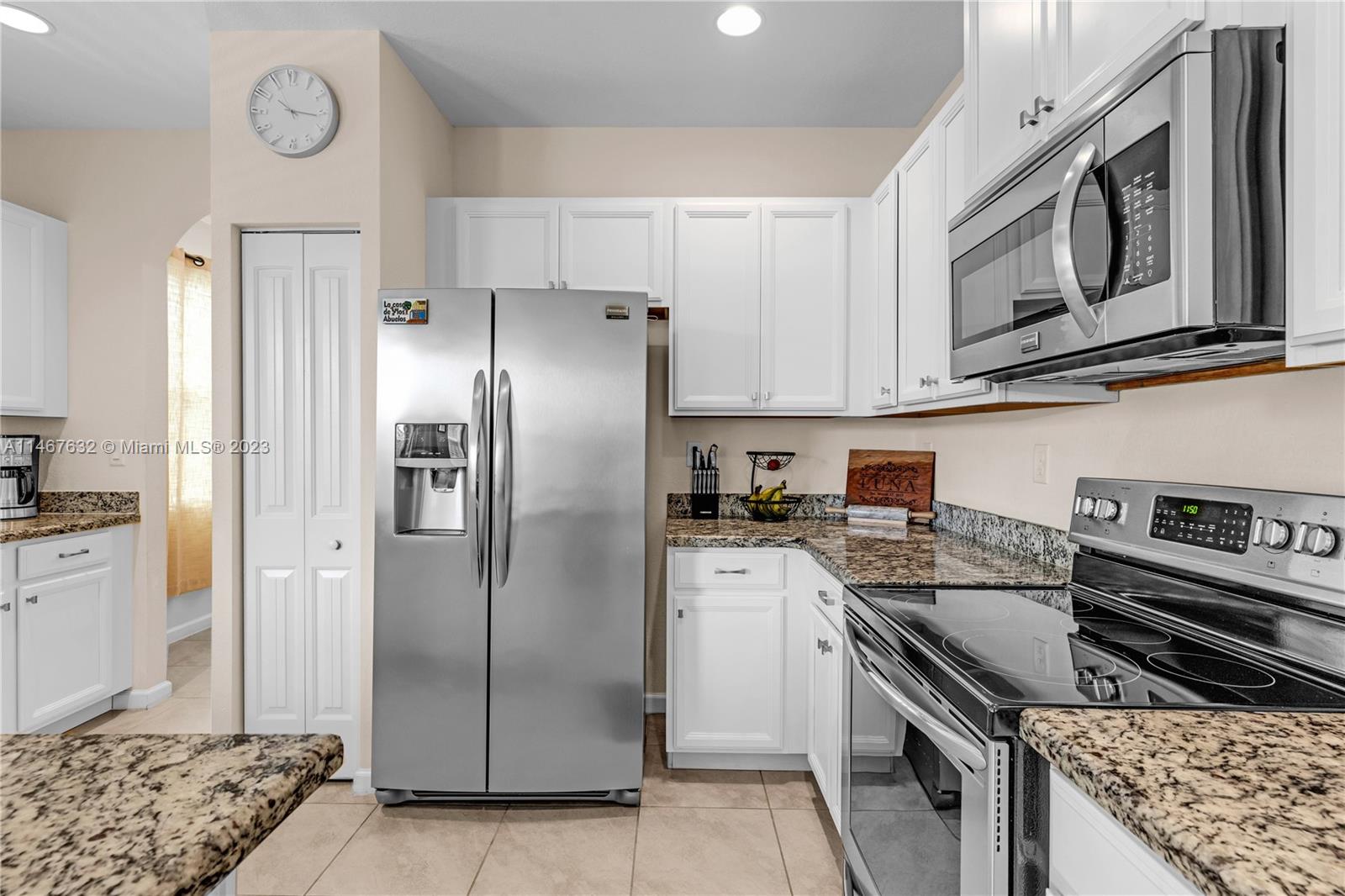 4144 Northeast 21st Street Homestead, FL 33033 - Photo 10 of 33 a kitchen with stainless steel appliances granite countertop a stove a refrigerator and a refrigerator