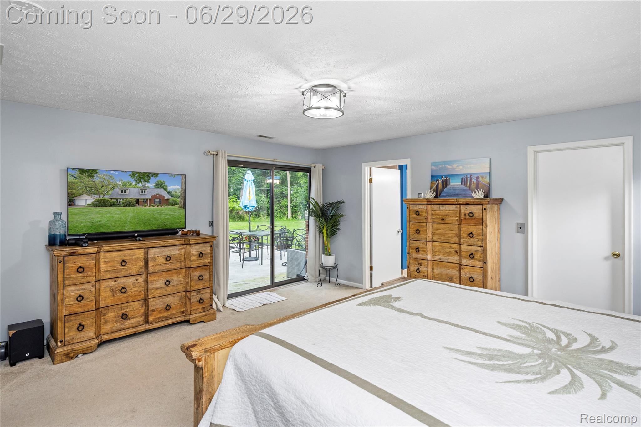 6085 Worlington Road Bloomfield Hills, MI 48301 - Photo 36 of 75 Primary Bedroom features a Sliding glass door access to the outdoor patio, featuring a ceiling light fixture and light-colored walls