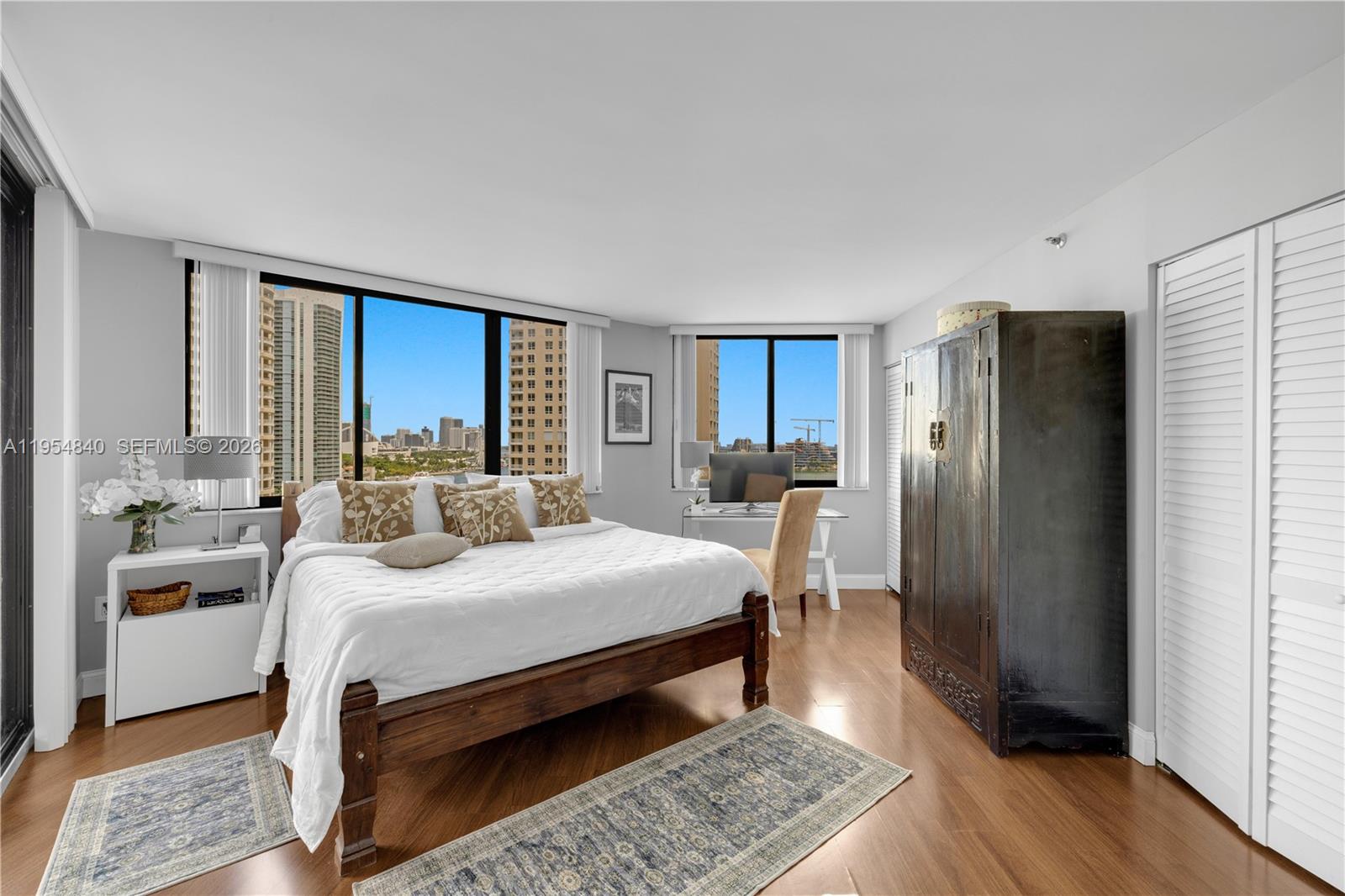 540 Brickell Key Drive, Unit 1514 Miami, FL 33131 - Photo 14 of 22 a bedroom with a bed and a refrigerator