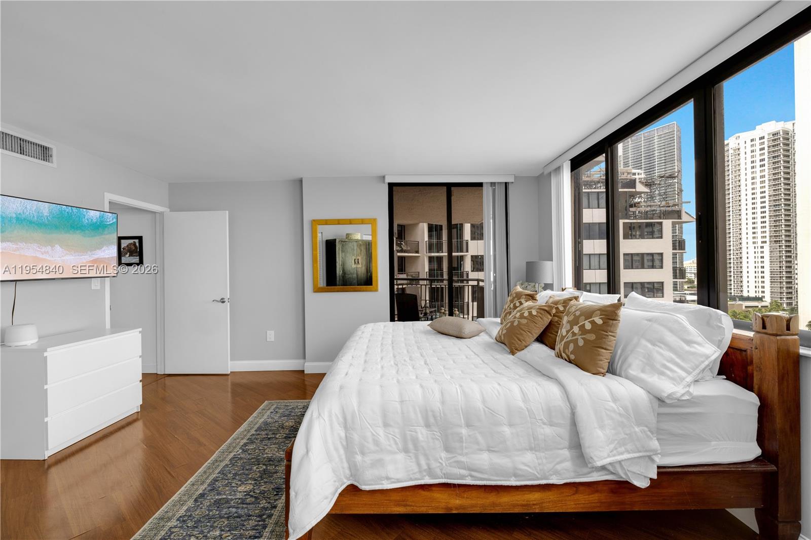 540 Brickell Key Drive, Unit 1514 Miami, FL 33131 - Photo 17 of 22 a bedroom with a bed and a large window