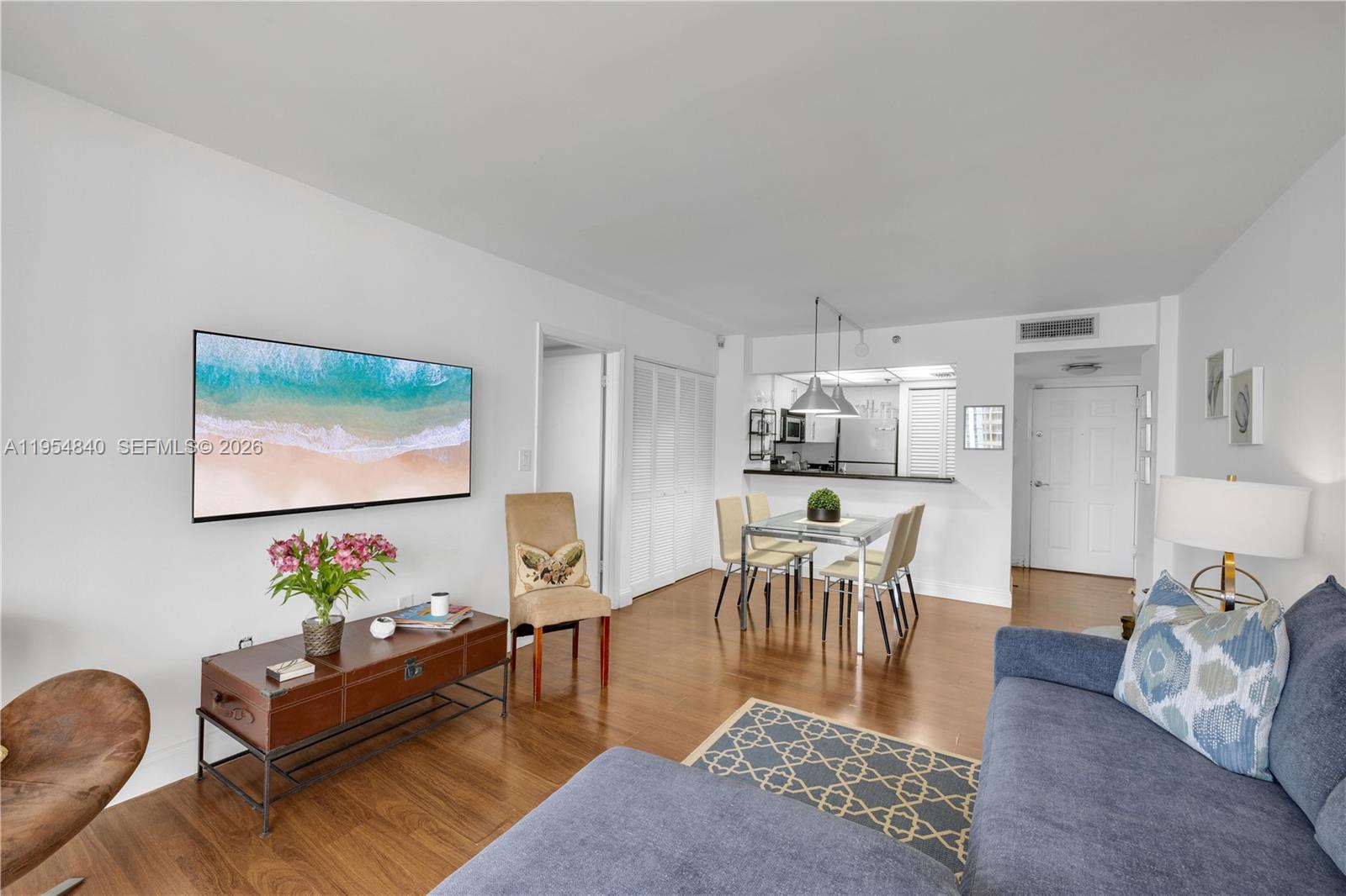 540 Brickell Key Drive, Unit 1514 Miami, FL 33131 - Photo 7 of 22 a living room with furniture and a dining area