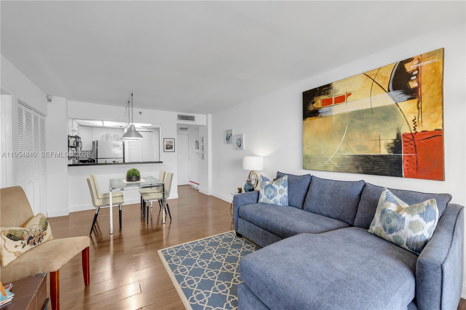 540 Brickell Key Drive, Unit 1514 Miami, FL 33131 - Photo 8 of 22 a living room with furniture wooden floor and a large window