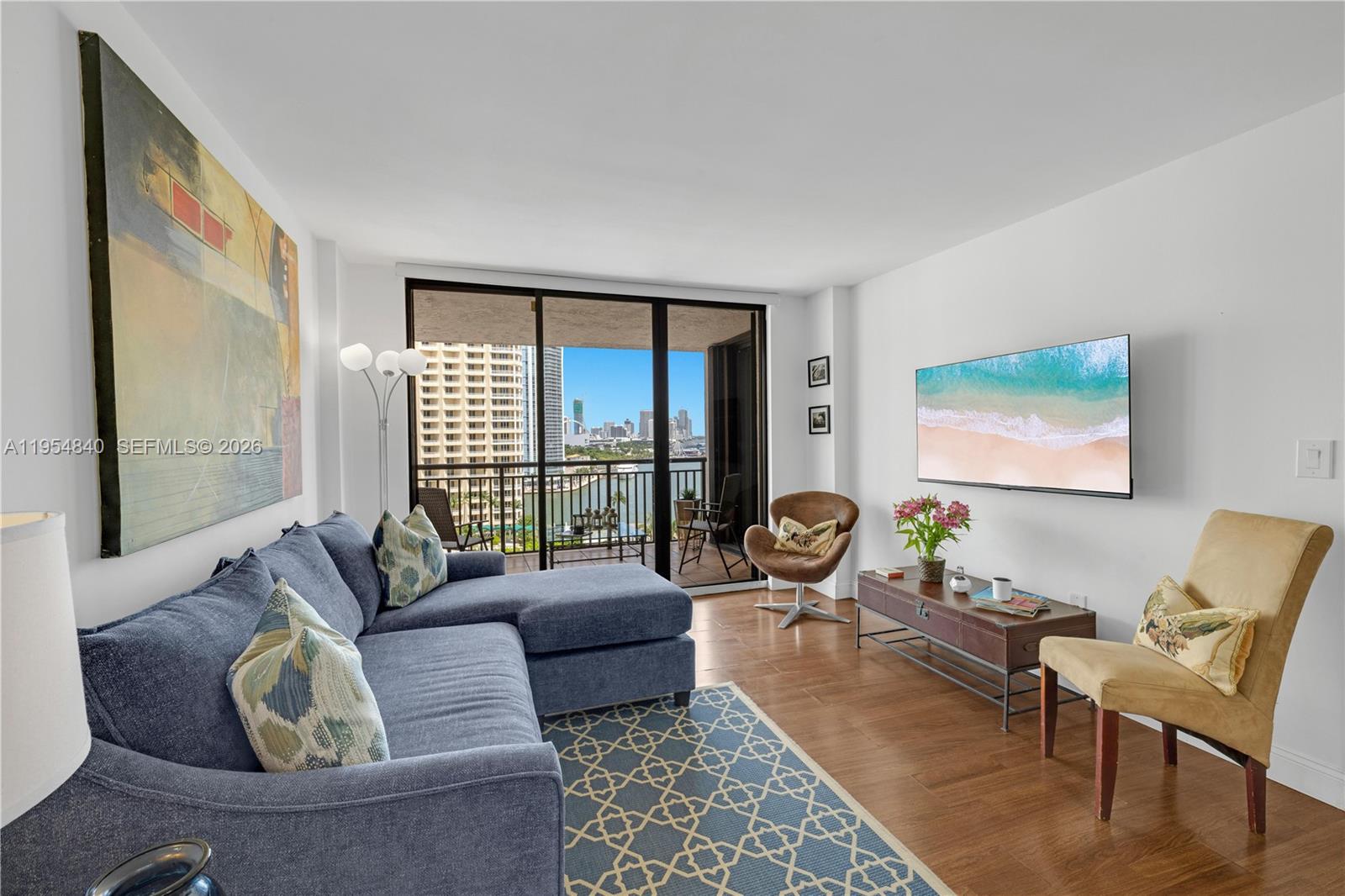 540 Brickell Key Drive, Unit 1514 Miami, FL 33131 - Photo 9 of 22 a living room with furniture and a large window