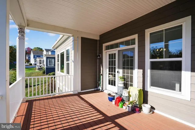a bedroom with a bed and a dresser next to a window