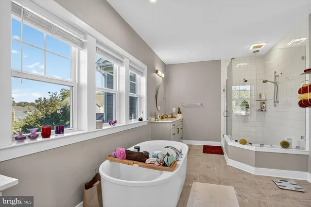 a bedroom with bed and a flat tv screen on the dresser