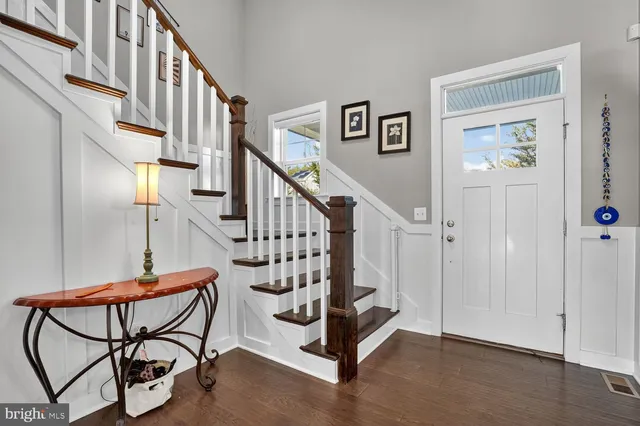 a view of a dining room with furniture wooden floor and a chandelier