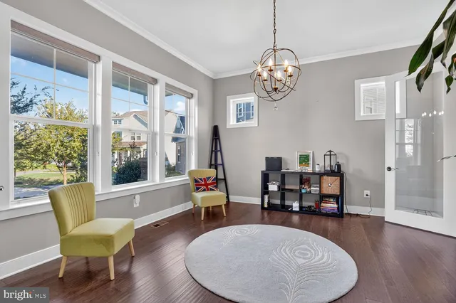 a view of a livingroom with furniture and hardwood floor