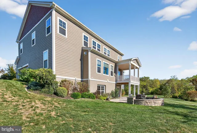 a backyard of a house with lots of green space and lake view