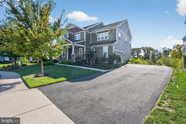 a view of a house with a yard and a garden
