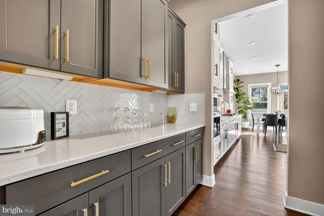 a kitchen with stainless steel appliances granite countertop a sink refrigerator and cabinets
