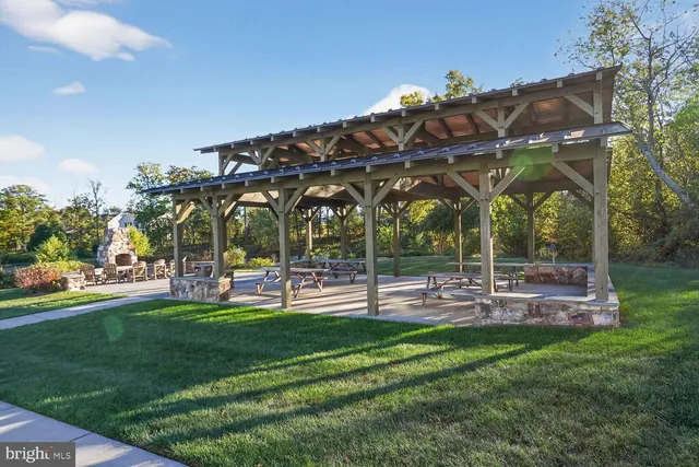 a view of a chairs and table in patio with a yard