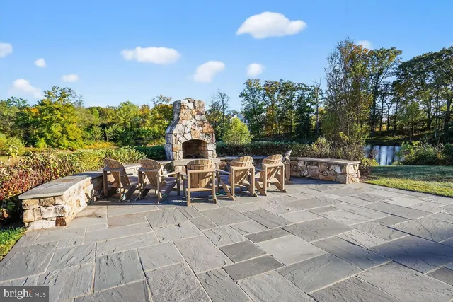 a view of a lake with a yard and large trees