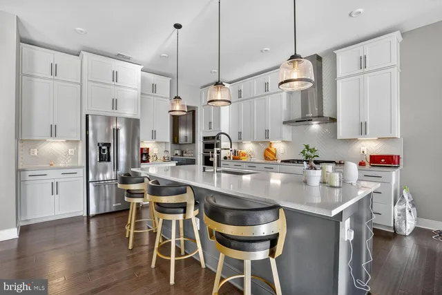 a living room with furniture and kitchen view
