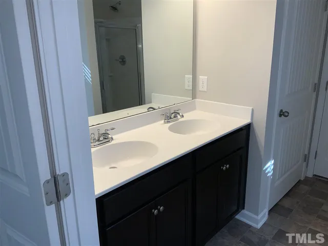a bathroom with a sink vanity and a mirror