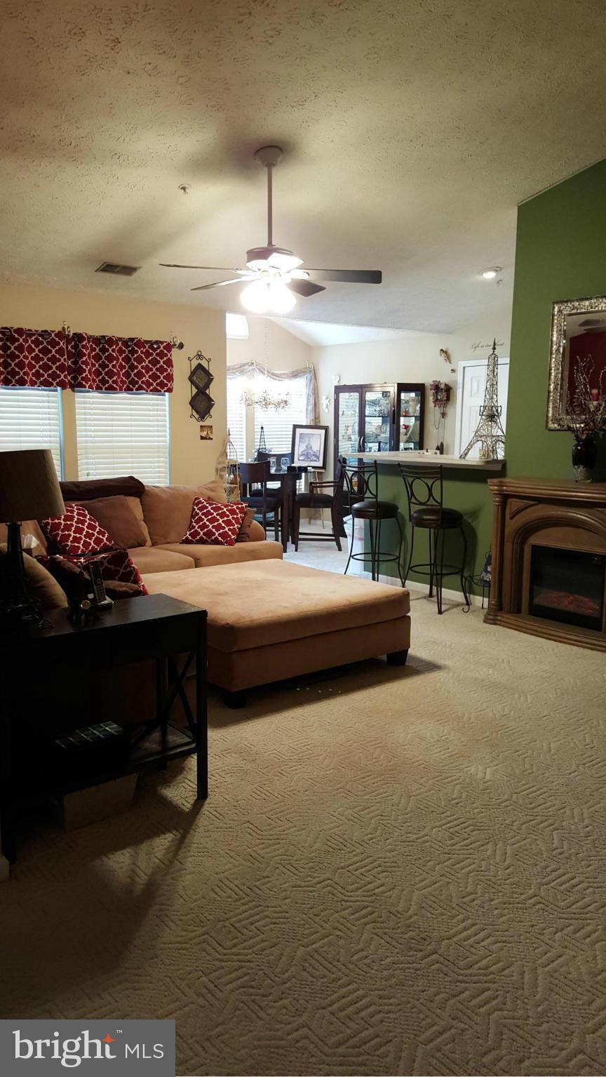 9765 Reese Farm Road, Unit L Owings Mills, MD 21117 - Photo 13 of 17 a living room with furniture and a fireplace