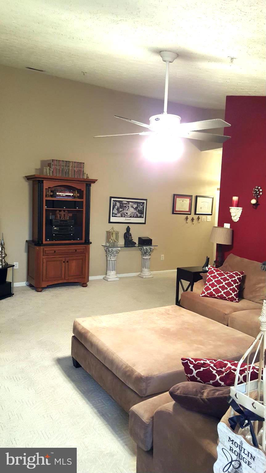 9765 Reese Farm Road, Unit L Owings Mills, MD 21117 - Photo 15 of 17 a bedroom with furniture and a flat screen tv