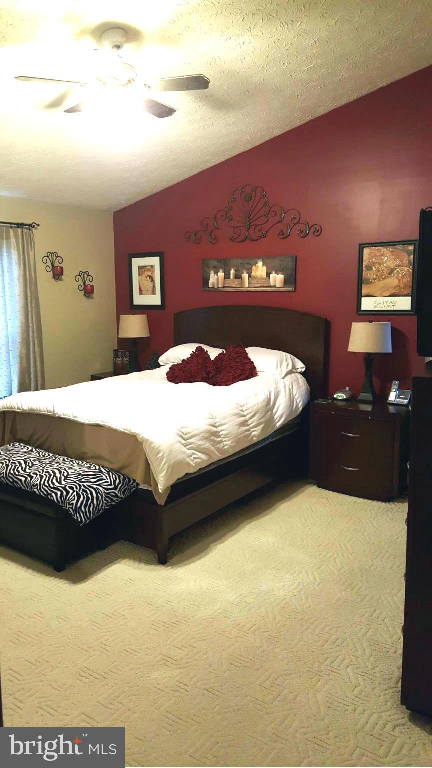 9765 Reese Farm Road, Unit L Owings Mills, MD 21117 - Photo 17 of 17 a bedroom with a bed and dresser