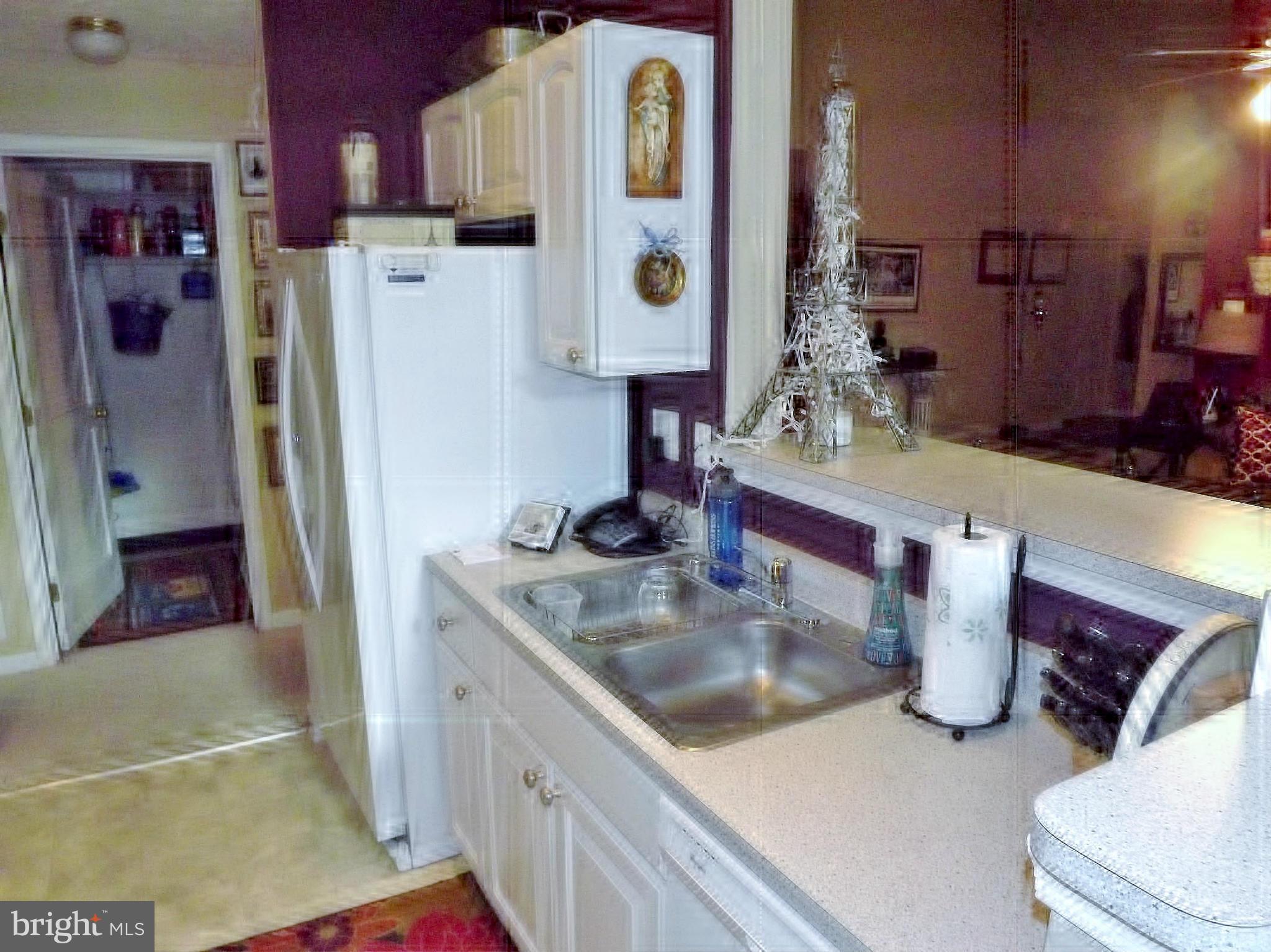 9765 Reese Farm Road, Unit L Owings Mills, MD 21117 - Photo 5 of 17 a kitchen with refrigerator and sink