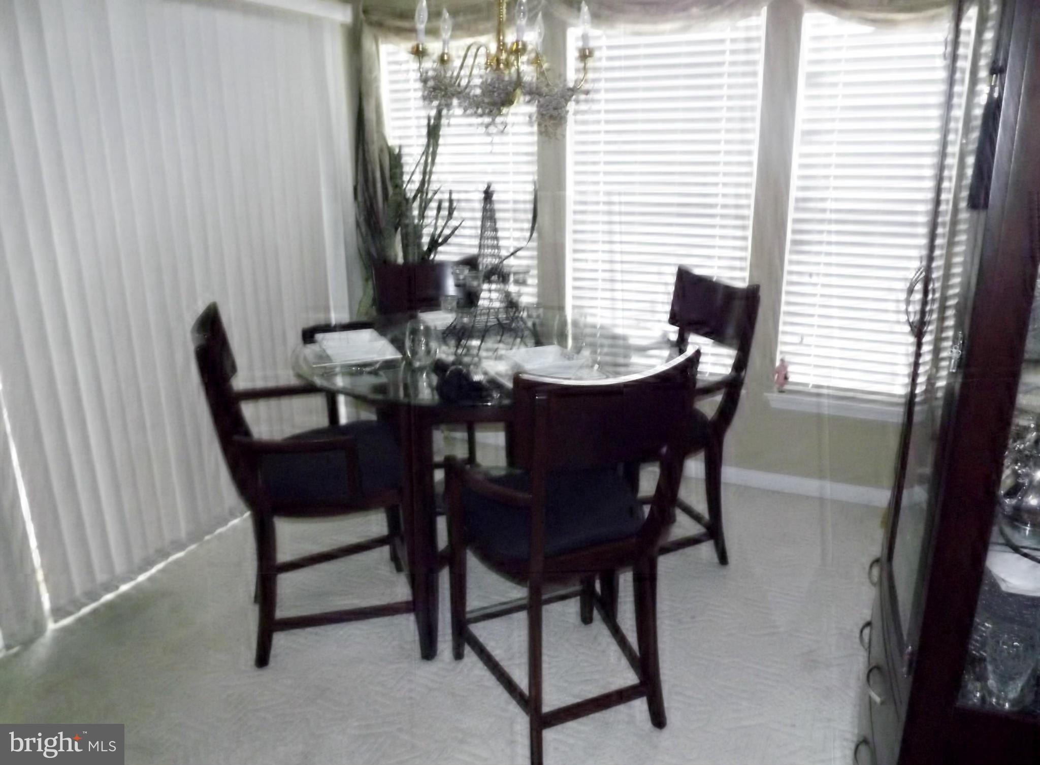 9765 Reese Farm Road, Unit L Owings Mills, MD 21117 - Photo 6 of 17 a view of a dining room with furniture and window
