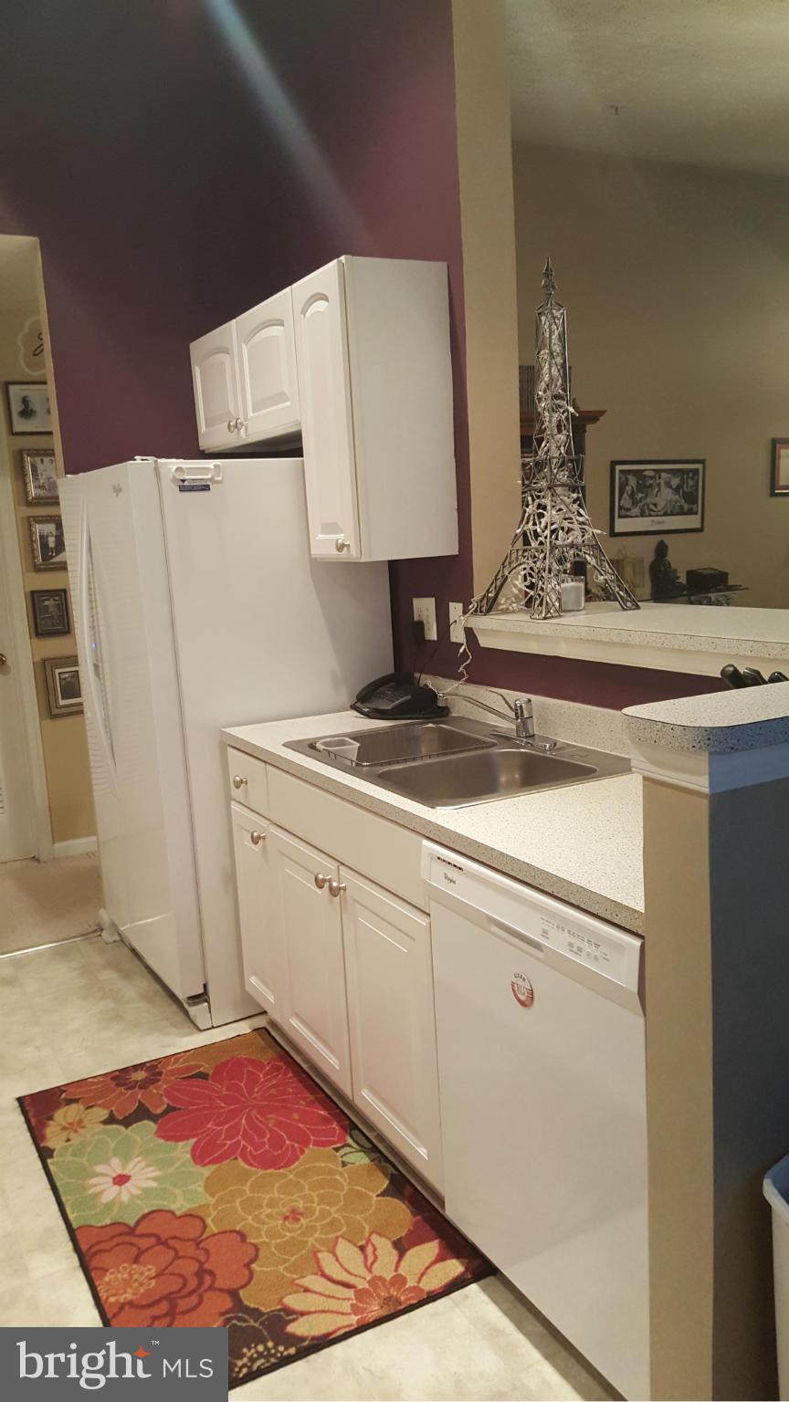 9765 Reese Farm Road, Unit L Owings Mills, MD 21117 - Photo 8 of 17 a view of a kitchen with refrigerator and stove