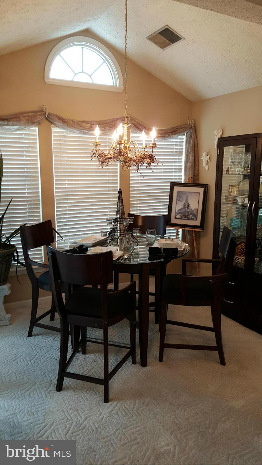 9765 Reese Farm Road, Unit L Owings Mills, MD 21117 - Photo 9 of 17 a view of a dining room with furniture and chandelier