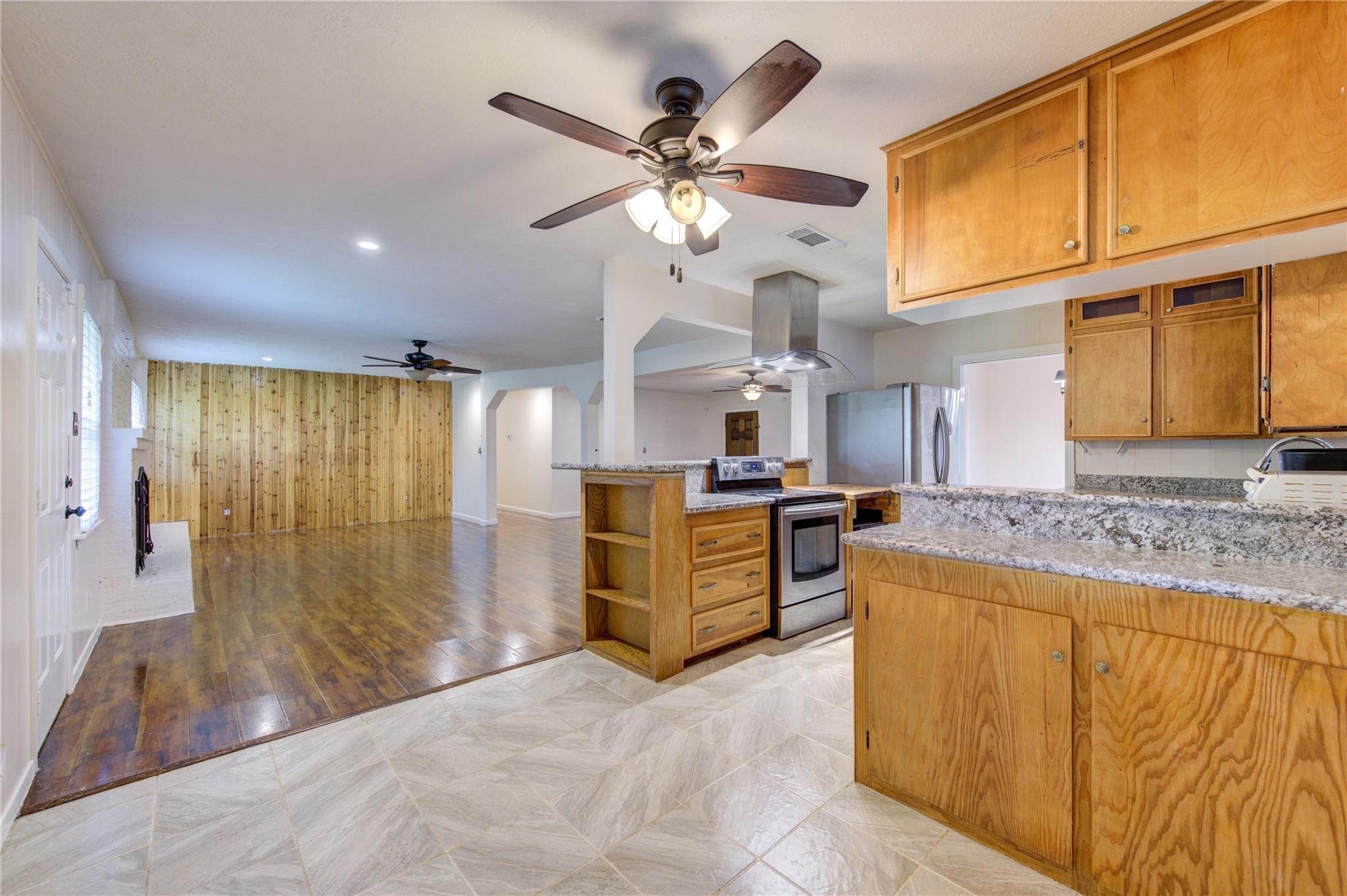 1745 Stone Road Pearland, TX 77581 - Photo 15 of 31 a kitchen with stainless steel appliances granite countertop a sink and cabinets
