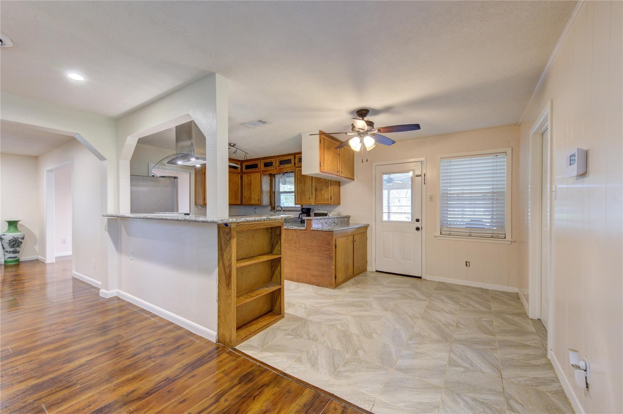 1745 Stone Road Pearland, TX 77581 - Photo 16 of 31 a view of a kitchen with cabinets and wooden floor