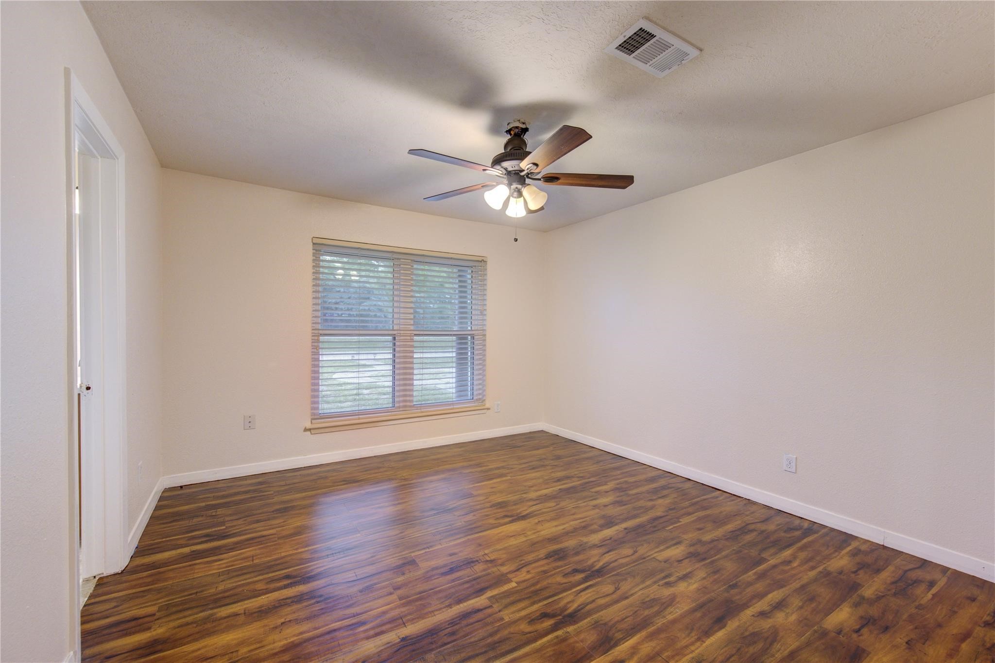 1745 Stone Road Pearland, TX 77581 - Photo 17 of 31 wooden floor in an empty room with a window