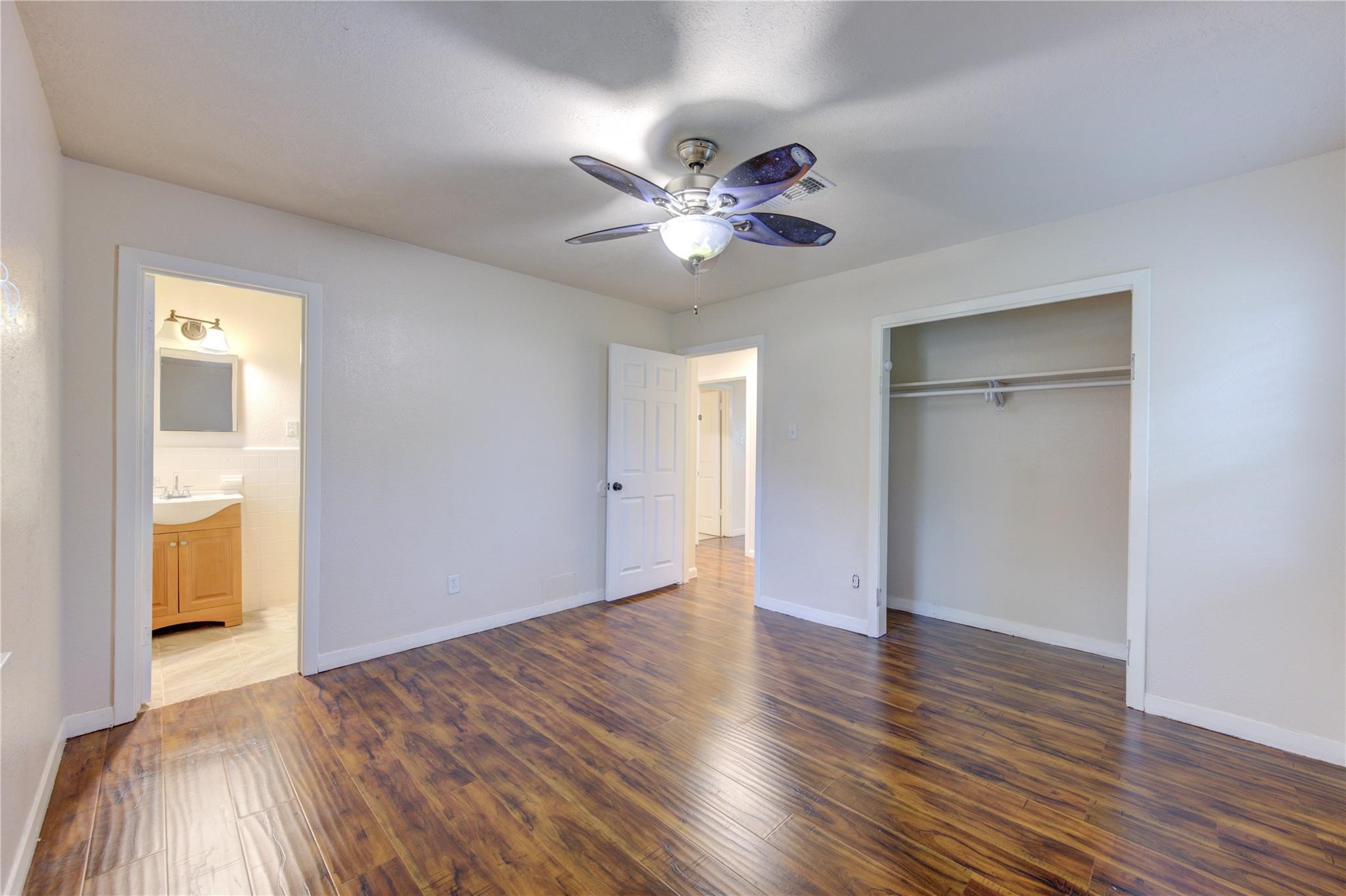 1745 Stone Road Pearland, TX 77581 - Photo 20 of 31 a view of an empty room with wooden floor