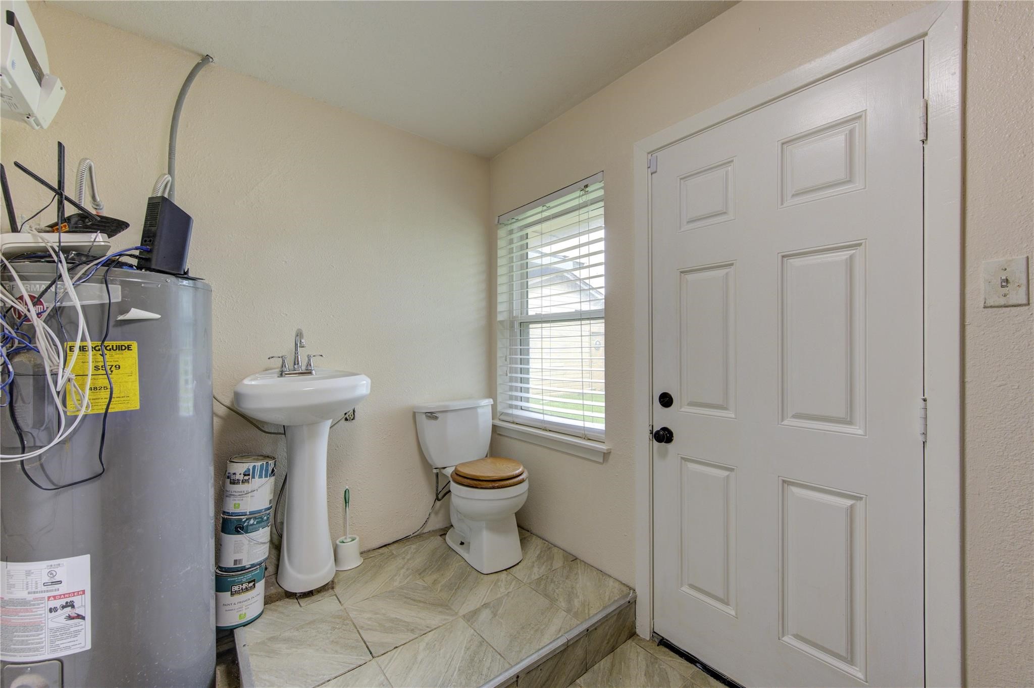 1745 Stone Road Pearland, TX 77581 - Photo 25 of 31 a bathroom with a toilet sink and mirror