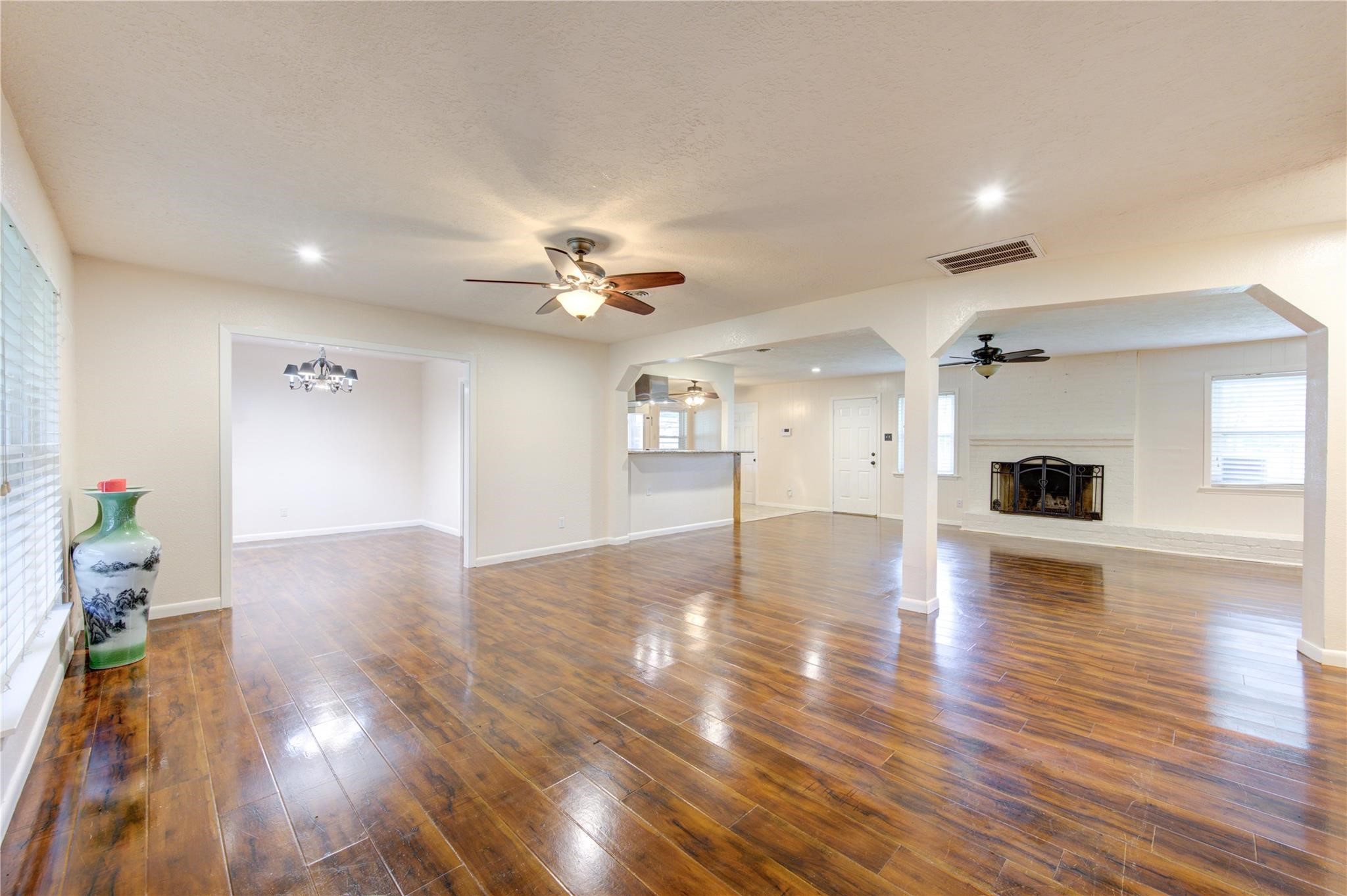 1745 Stone Road Pearland, TX 77581 - Photo 5 of 31 a view of livingroom and kitchen with wooden floor