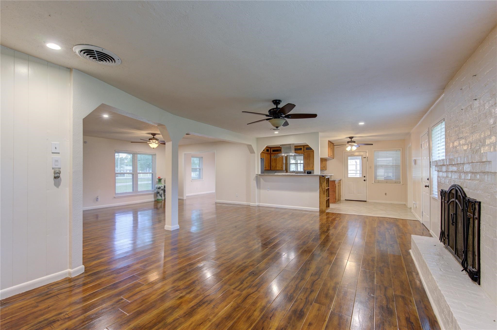 1745 Stone Road Pearland, TX 77581 - Photo 7 of 31 a view of empty room with wooden floor and fan