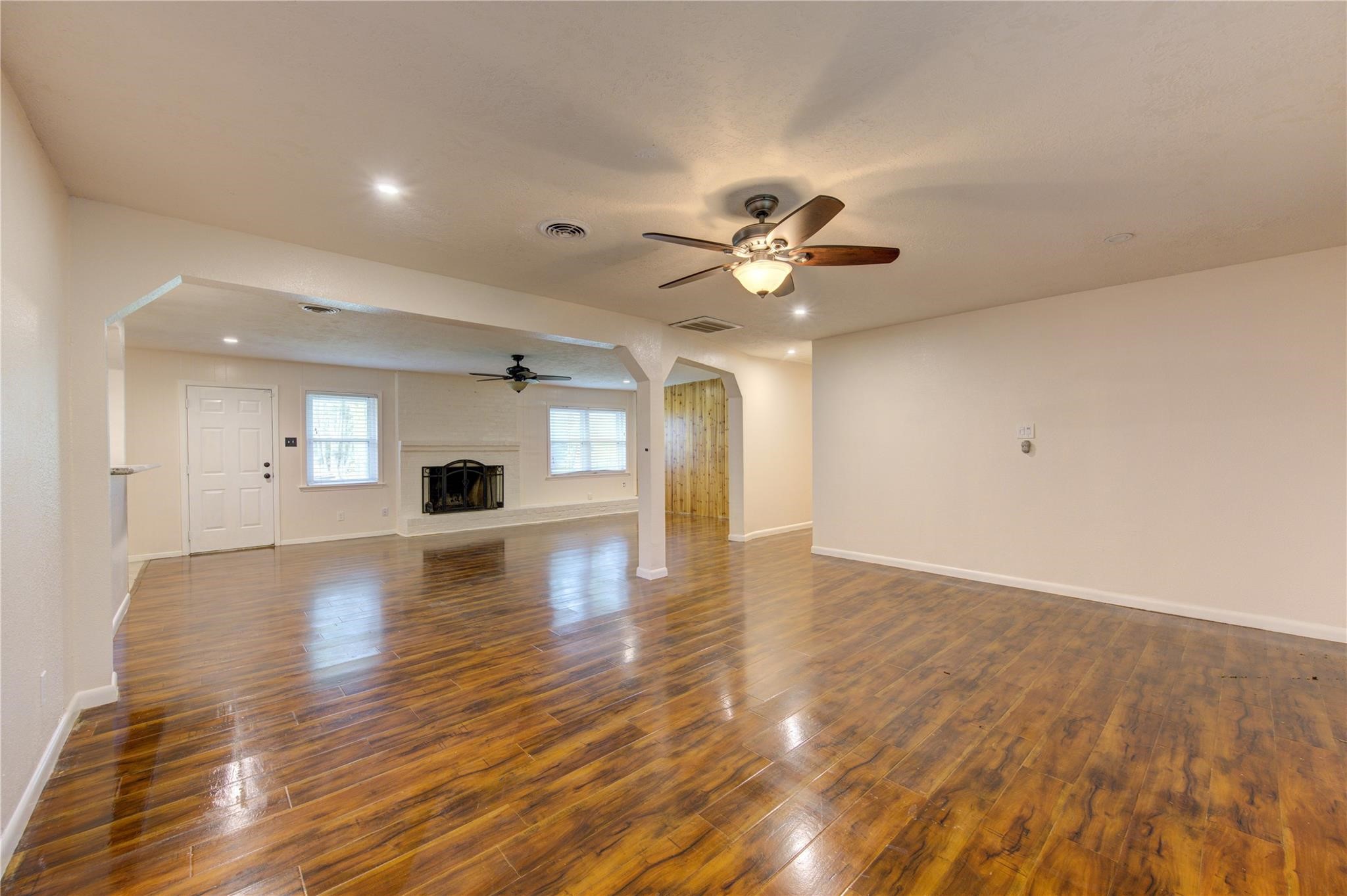 1745 Stone Road Pearland, TX 77581 - Photo 9 of 31 a view of empty room with wooden floor and window