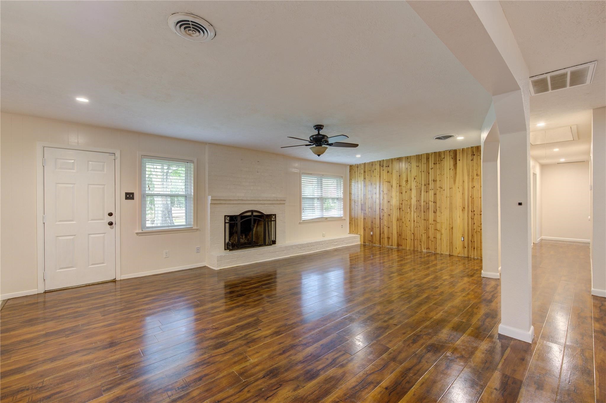 1745 Stone Road Pearland, TX 77581 - Photo 10 of 31 an empty room with wooden floor and windows