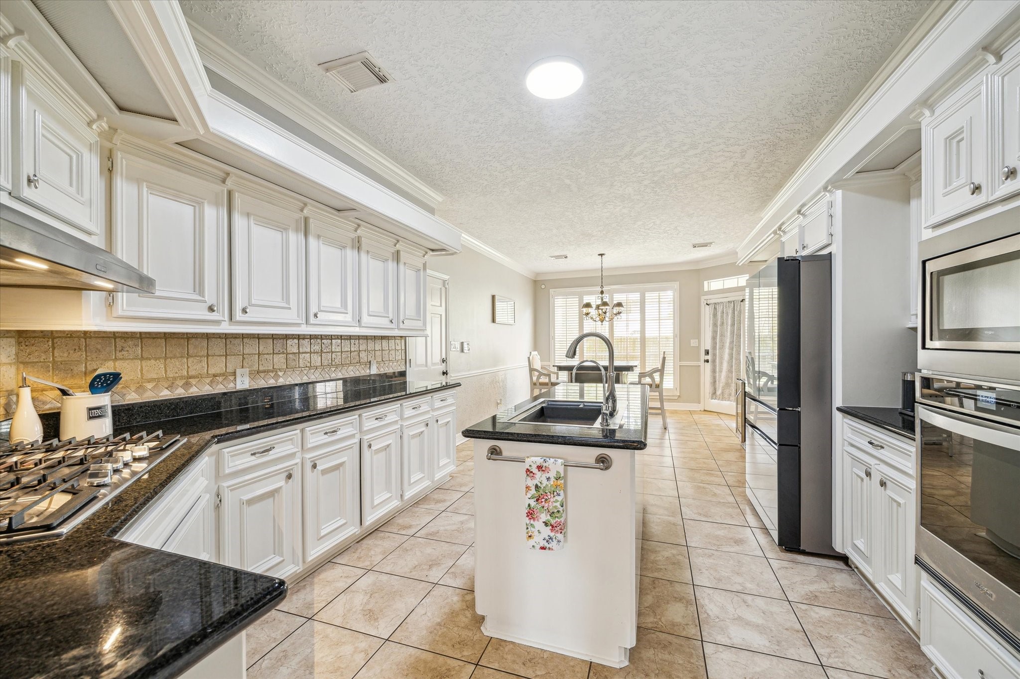 15314 Ripplewind Lane Houston, TX 77068 - Photo 9 of 24 a kitchen with stainless steel appliances granite countertop a sink stove and refrigerator