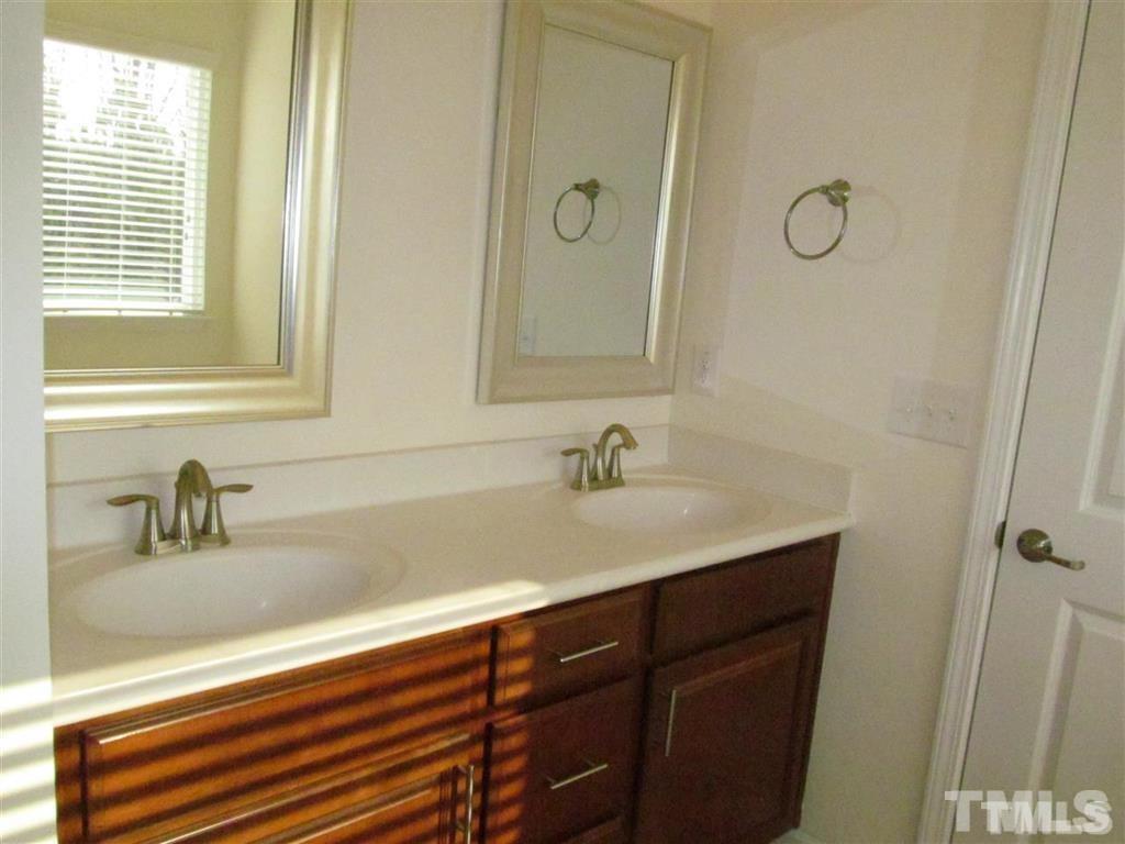 4956 Highcroft Drive Cary, NC 27519 - Photo 12 of 17 a bathroom with a sink and a mirror