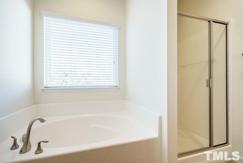 4956 Highcroft Drive Cary, NC 27519 - Photo 13 of 17 a white bath tub with a shower