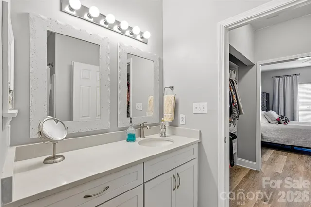 a bathroom with a double vanity sink mirror and shower