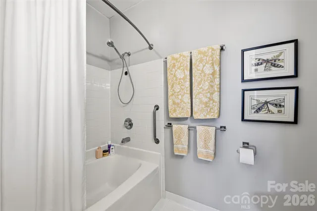 a bathroom with a bathtub and a shower