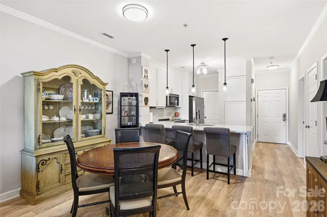 a view of a dining room with furniture and a chandelier