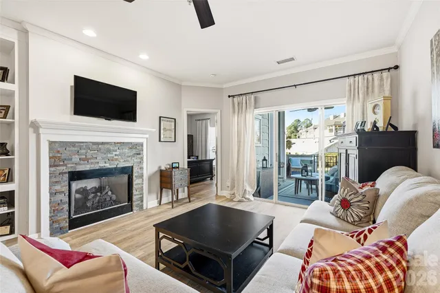 a living room with furniture a flat screen tv and a fireplace
