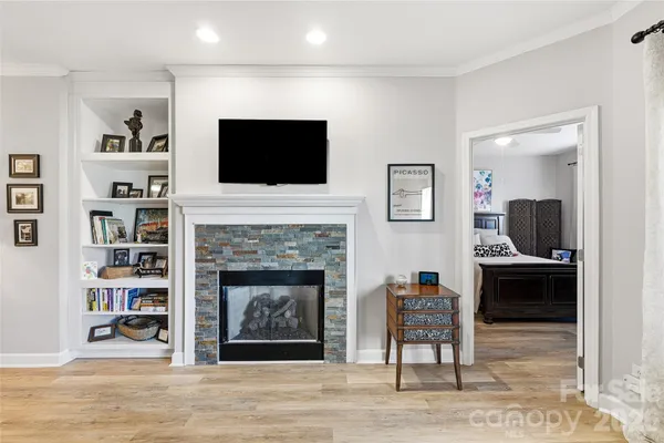 a living room with furniture a flat screen tv and a fireplace